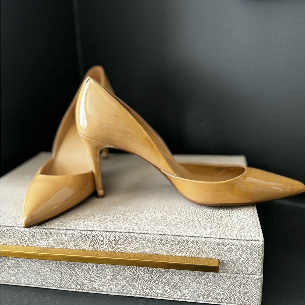 Nude patent leather Michael Kors pumps.